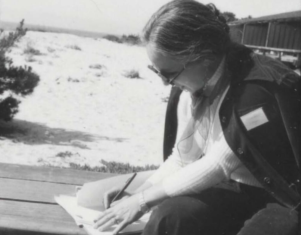 woman seated writing notes