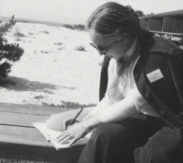 woman seated writing notes