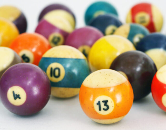 Color photo of old billiard balls on white background