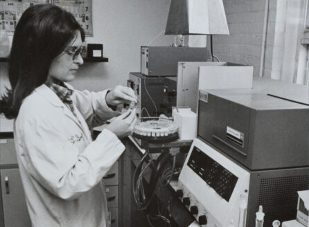 woman in lab coat testing samples
