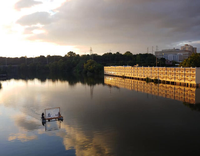 floating movie screen over the Schuylkill River at dusk