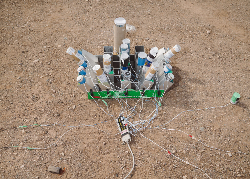tangle of cables and canisters on sandy ground