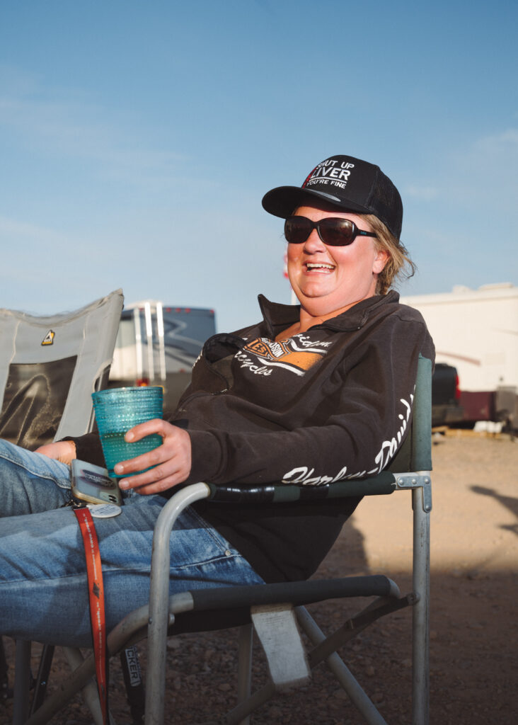 Smiling woman wearing sunglasses seated in camp chair