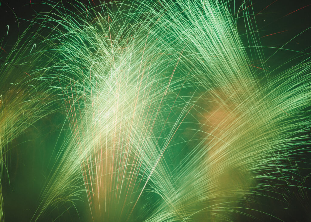 Abstract image of green fireworks flares