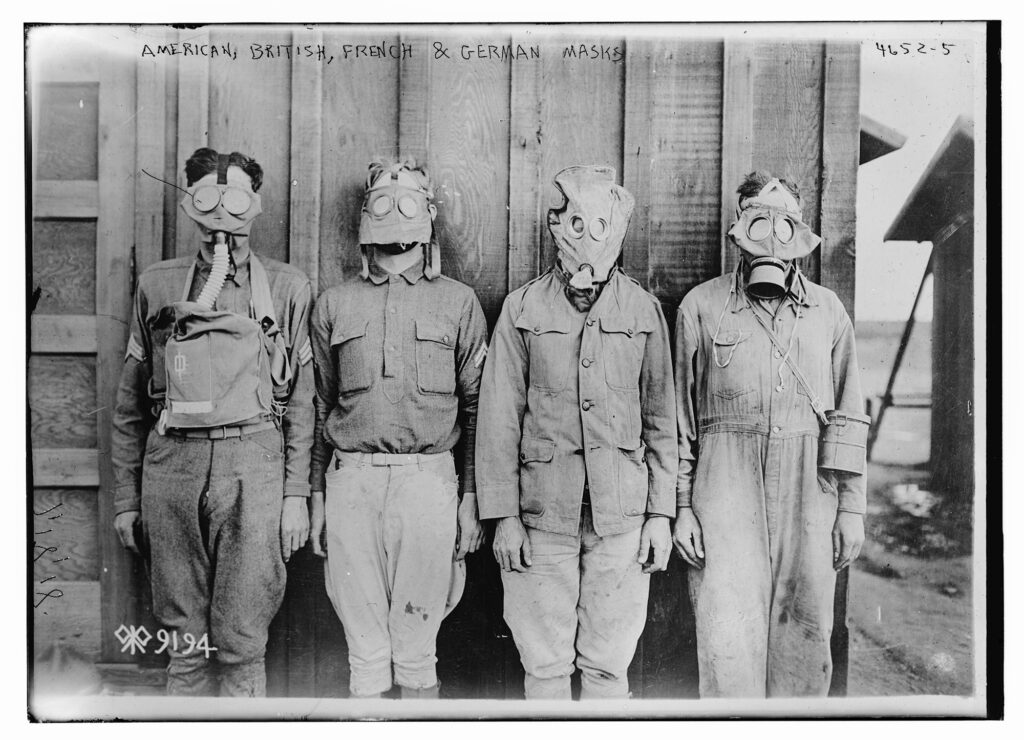 Photo of four men wearing different versions of gas masks