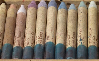 Interior of a box of 22 old, faded crayons