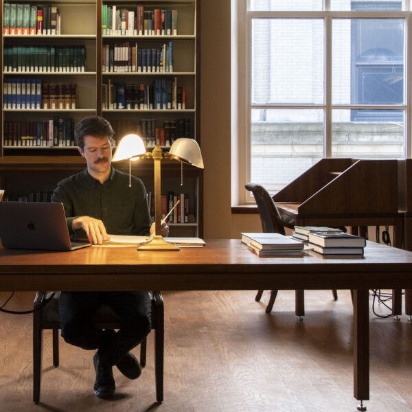 man doing research in a library
