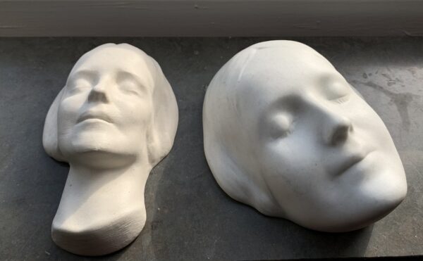 Two plaster masks of a woman