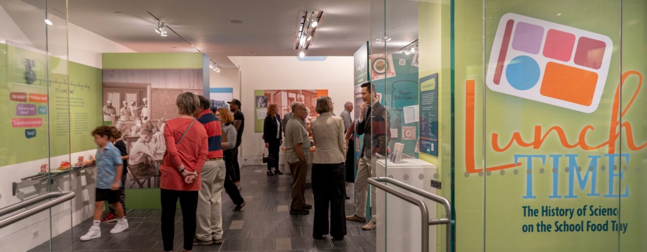 people standing in a museum exhibit