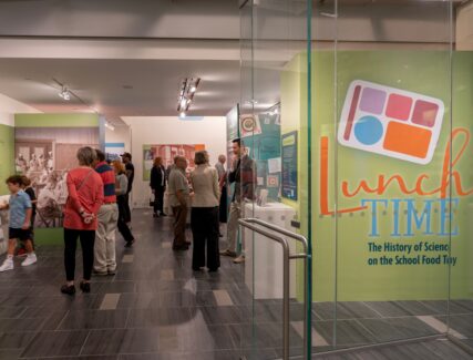 people standing in a museum exhibit