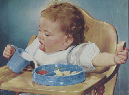 magazine ad featuring a baby in high chair pouring milk over a tray