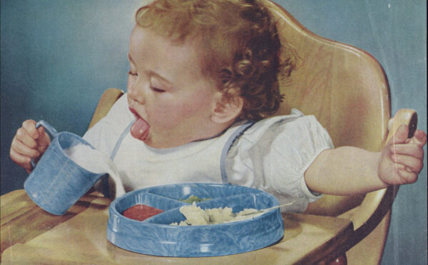 magazine ad featuring a baby in high chair pouring milk over a tray