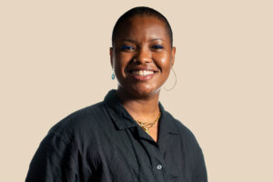 Akilah Chatman, smiling, wearing a black button-down