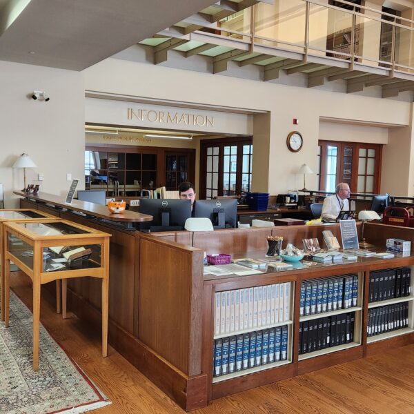 2 people sitting at a library information desk