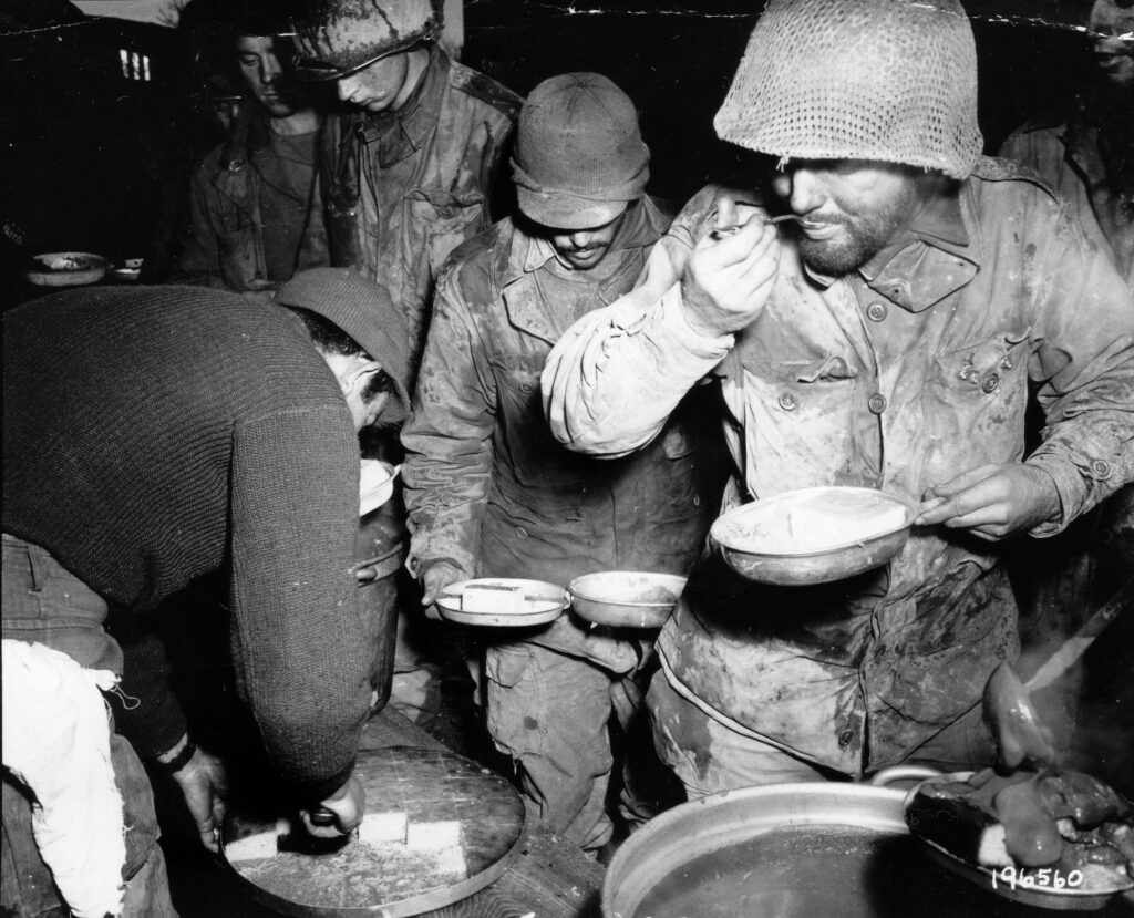 Black and white photo of troops at chow line