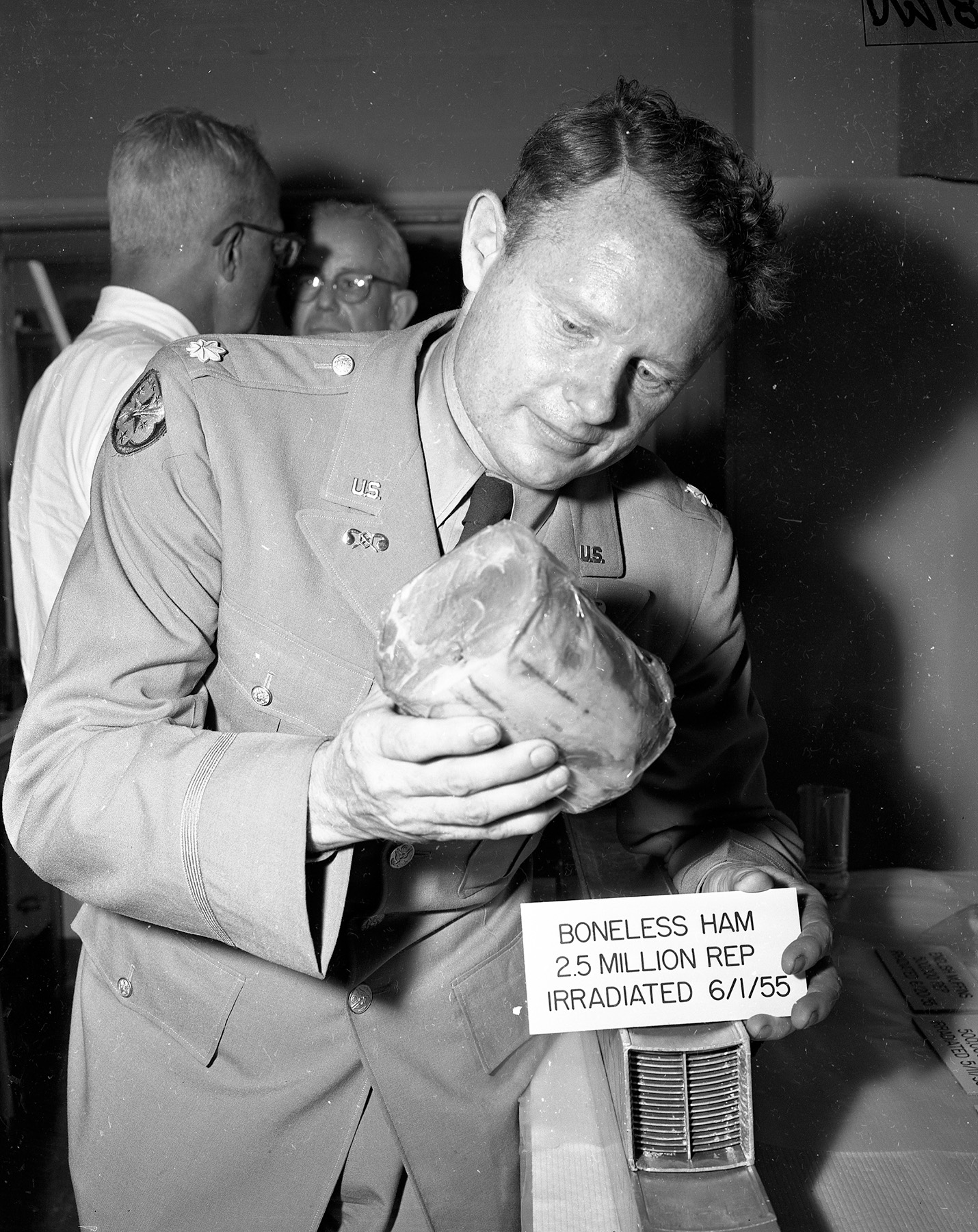 Army officer inspects irradiated ham display