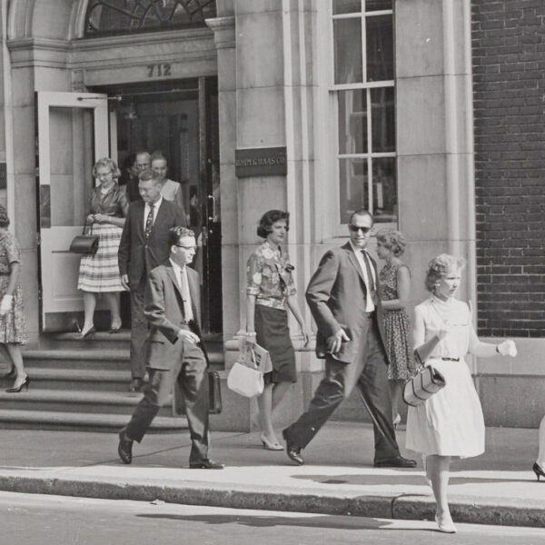 A black and white photo from 1965 of Rohm and Haas employees leaving the company's Philadelphia office