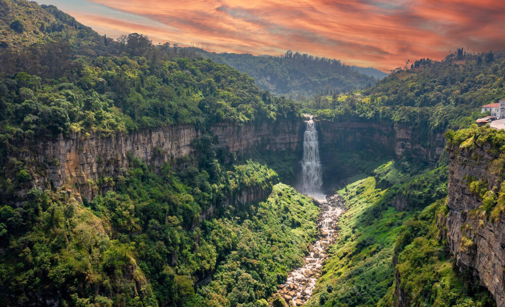 Aerial color photo of a steep waterfall in a rocky jungle environment