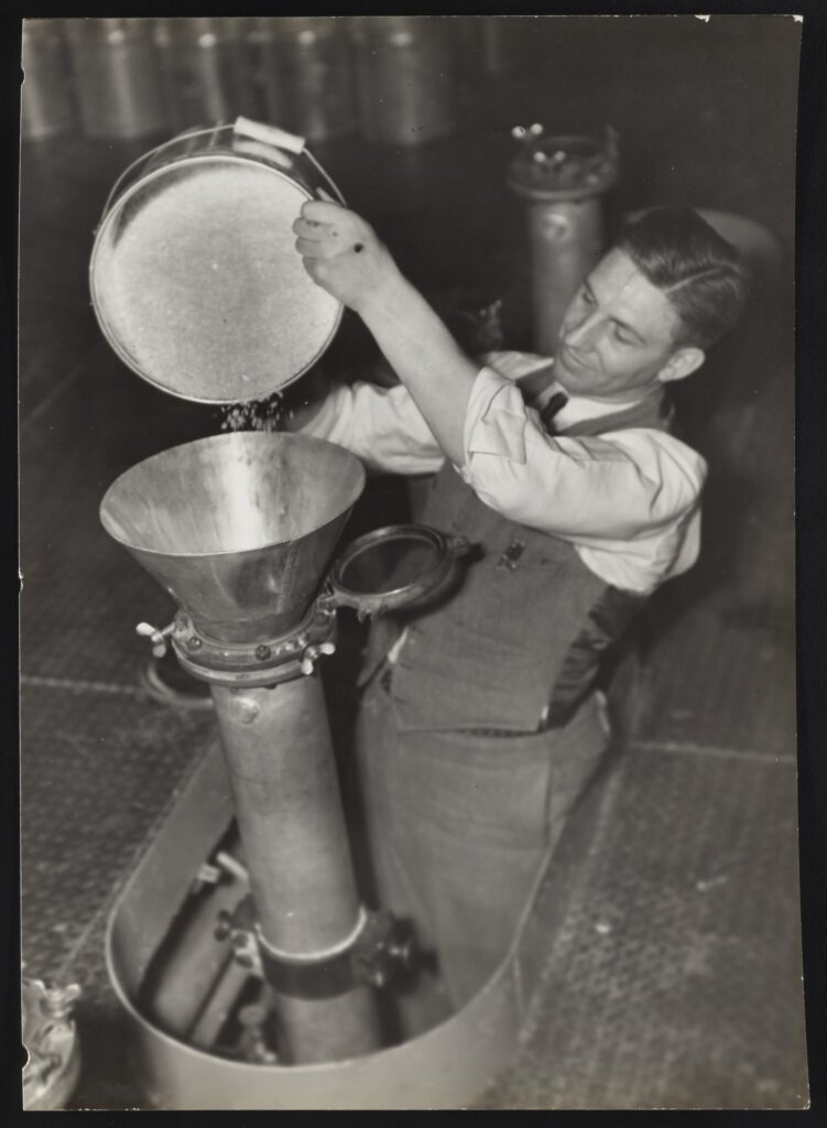 man feeding chips into a machine