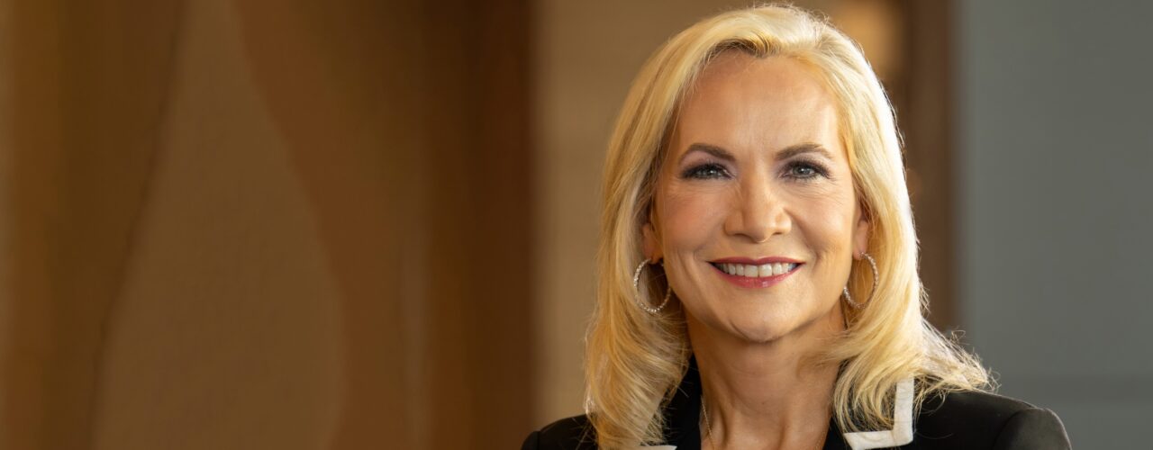 headshot of a blond woman in a suit jacket