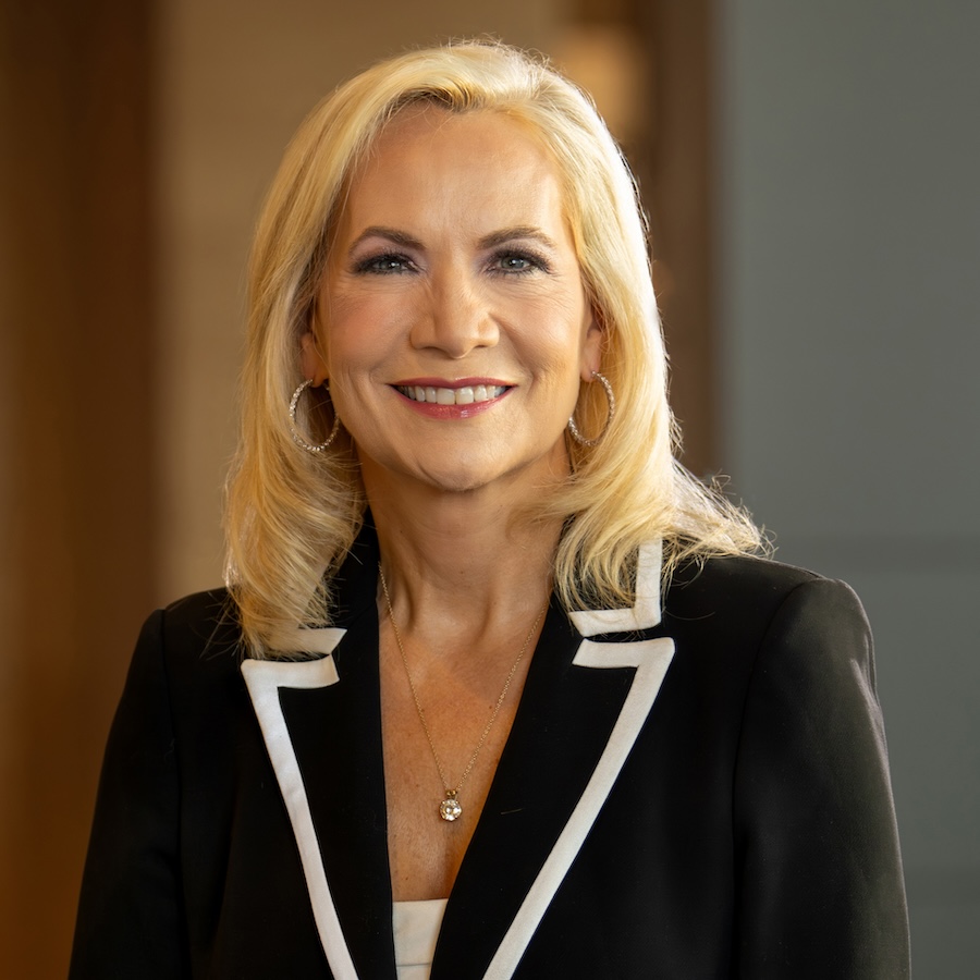 headshot of a blond woman in a suit jacket