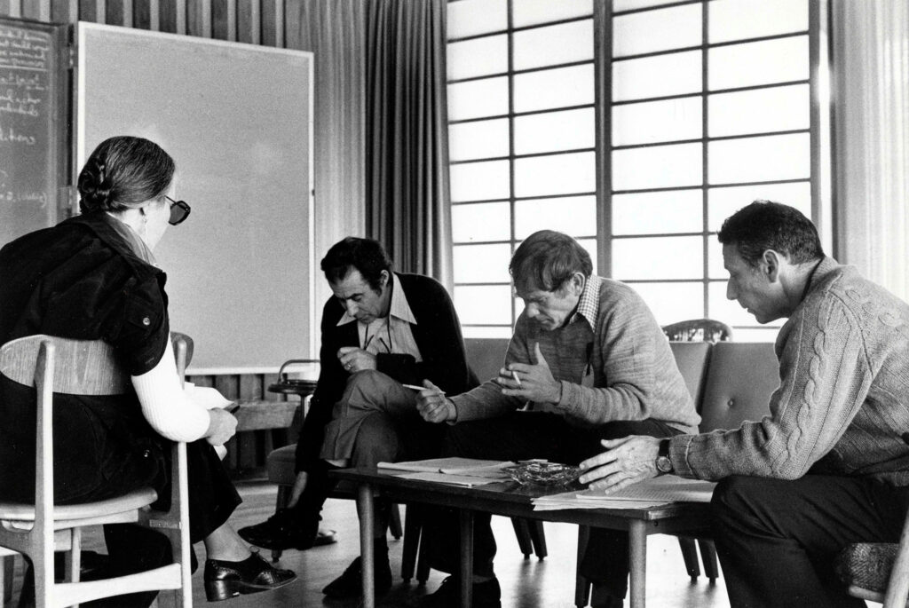 Four people seated and in discussion