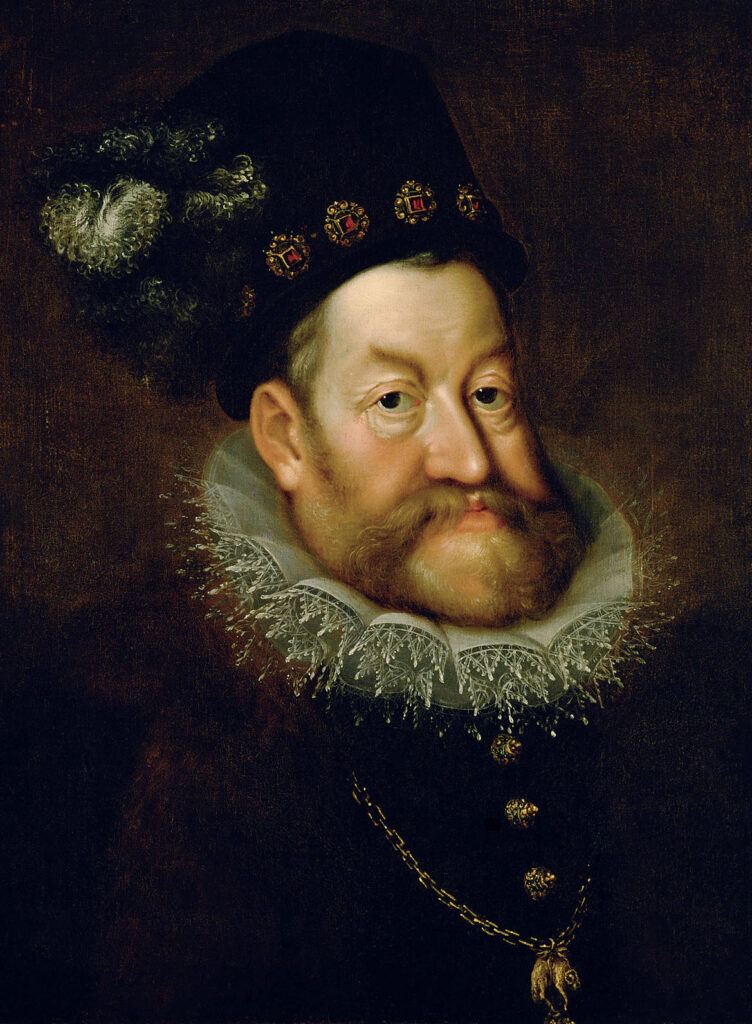 Oil painting of an older bearded man in a bejeweled hat and high collar