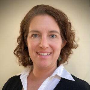 Emily Levitt Ruppert, smiling, wearing white collared shirt and blazer