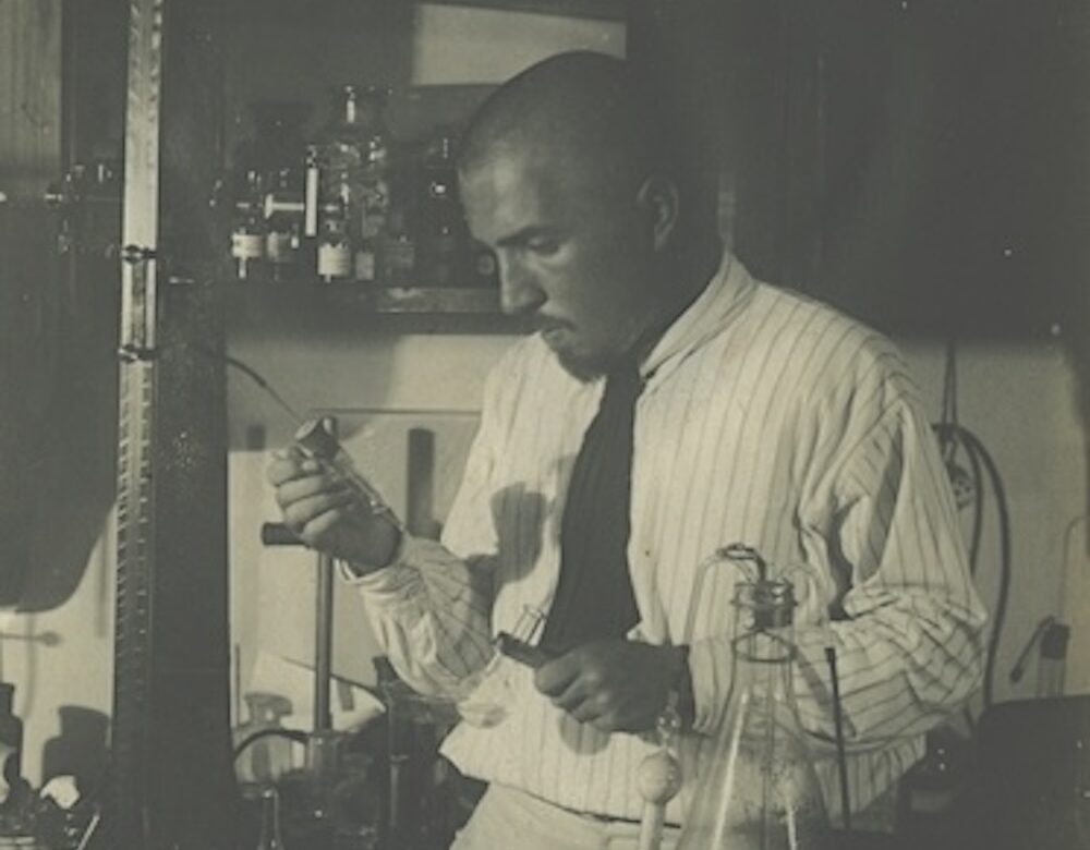 black and white photo of a man in a lab