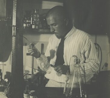 black and white photo of a man in a lab