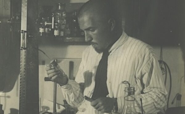 black and white photo of a man in a lab